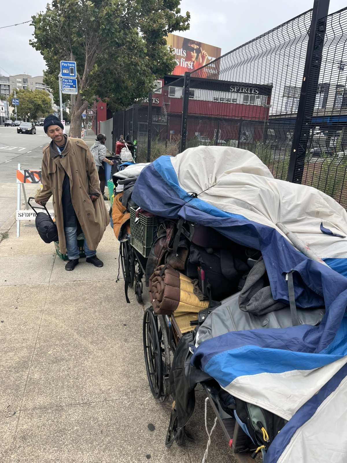 Fable Idris helps his friends assemble a 'wagon train' of possessions, as they stay ahead of an encampment sweep by city workers south of Market Street.