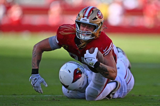 San Francisco 49ers' George Kittle (85) is tackled by Arizona Cardinals' Dadrion Taylor-Demerson (42) while attempting to get a first down in the fourth quarter of their NFL game at Levi's Stadium in Santa Clara, Calif., on Sunday, Oct. 6, 2024. The Arizona Cardinals defeated the San Francisco 49ers 24-23. (Jose Carlos Fajardo/Bay Area News Group)