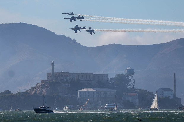 The U.S. Navy Blue Angels fly in formation over Alcatraz Island as part of the annual Fleet Week, as seen from Treasure Island in San Francisco, Calif., on Friday, Oct. 11, 2024. The air show and other attractions continue on Oct. 12 and 13. (Ray Chavez/Bay Area News Group)