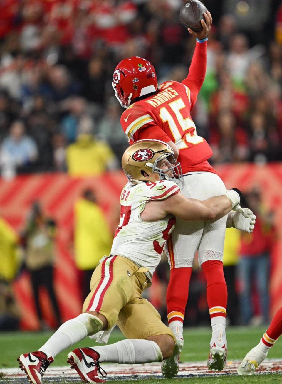 San Francisco 49ers defensive end Nick Bosa (97) grabs Kansas City Chiefs quarterback Patrick Mahomes (15) in the second half of Super Bowl LVIII, Sunday, Feb. 11, 2024, in Las Vegas.