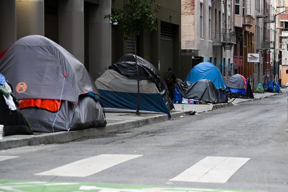 Several tents line a sidewalk in San Francisco.