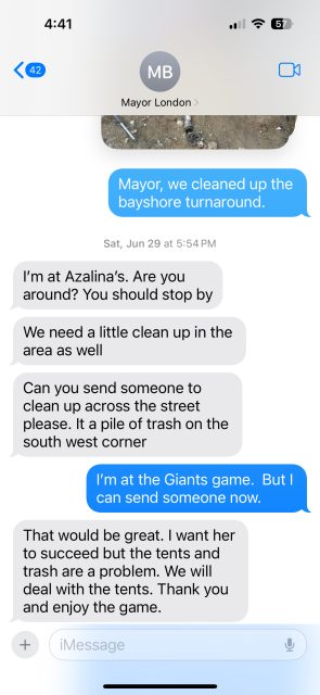 Text message exchange discussing a clean-up request across Bayshore turnaround, mentioning Azalina's and addressing trash issues. One party is at a Giants game, but willing to send help.