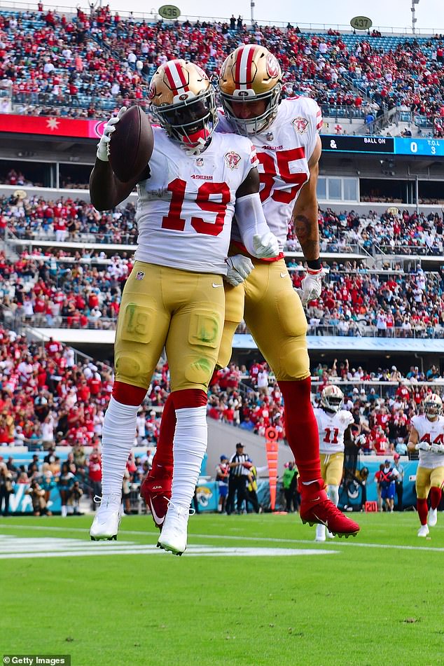 Deebo Samuel #19 of the 49ers celebrates with George Kittle #85 after scoring a touchdown