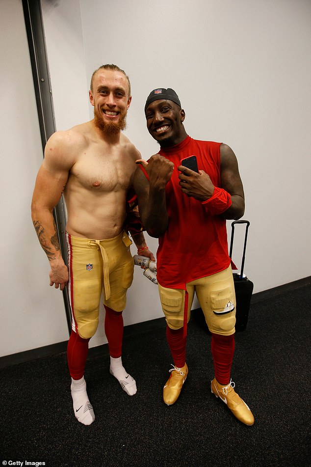 George Kittle #85 and Deebo Samuel #19 of the San Francisco 49ers in the locker room