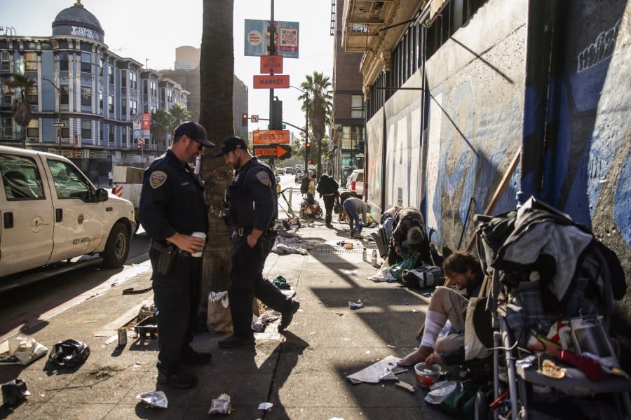 San Francisco Police officers ask people who are sitting and sleeping on the street to get up and move their belongings as they sweep 6th Street Oct. 14, 2024. (Photo by Gabrielle Lurie /San Francisco Chronicle via Getty Images)