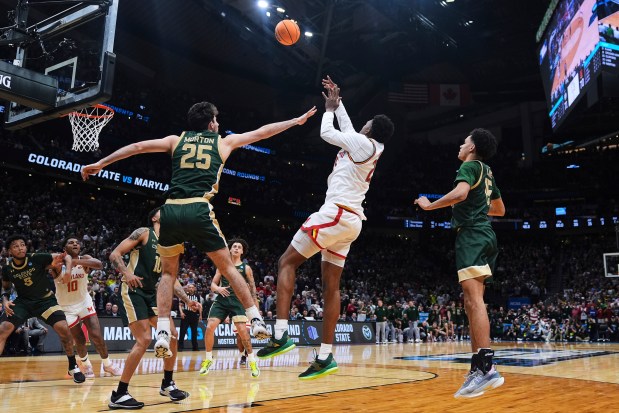 Maryland center Derik Queen, center, makes the game-winning basket against Colorado State guard Ethan Morton (25) and guard Jalen Lake, right, in the final seconds of the game in the second round of the NCAA college basketball tournament Sunday, March 23, 2025, in Seattle. (AP Photo/Lindsey Wasson)