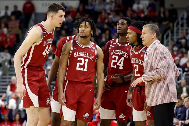 Head coach John Calipari of the Arkansas Razorbacks talks with the team against the St. John's Red Storm during the first half in the second round of the NCAA Men's Basketball Tournament at Amica Mutual Pavillion on March 22, 2025 in Providence, Rhode Island.  (Photo by Emilee Chinn/Getty Images)